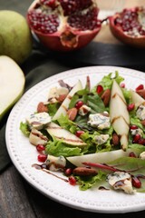 Delicious pear salad with sauce on wooden table, closeup