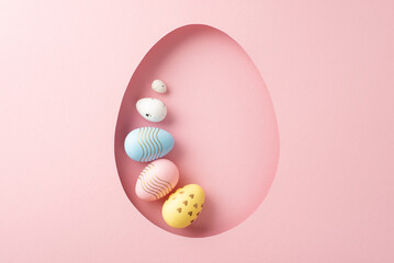 Celebratory Easter idea: top view of assorted eggs seen through an egg-shaped cutout on a delicate...