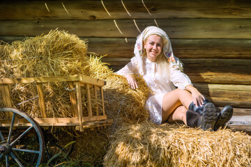 Beautiful blonde girl in the hayloft