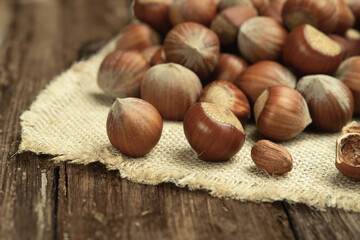 Hazelnuts in the shell close-up. Hazelnut on a wooden table. Natural food products. Close up, copy...