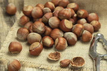 Hazelnuts in the shell close-up. Hazelnut on a wooden table. Natural food products. Close up, copy space