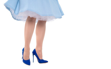 Perfect legs of female  in blue skirt  and  blue high heels shoes isolated on white background