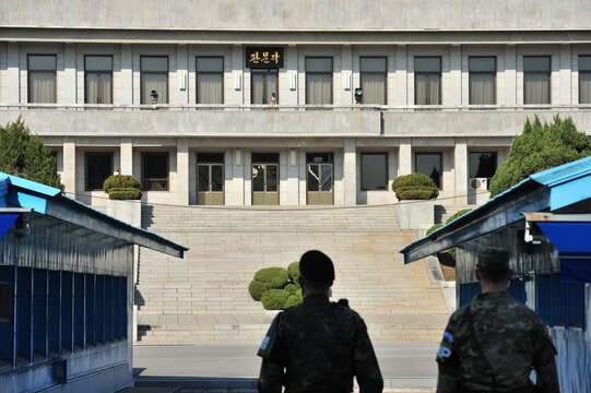 Korean Army guarding the Panmungak building in North Korea seen from South Korea across the Military Demarcation Line at Panmunjom in the JSA.