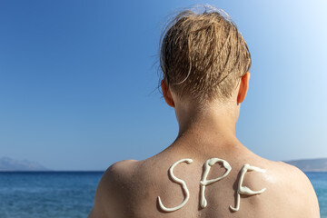 SPF inscription on the back. Skin protection concept. Selective focus