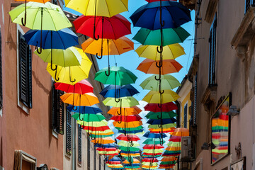 Colorful umbrellas hanging above a street