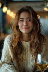 Obraz premium Charming Asian Woman Enjoying a Glass of Wine