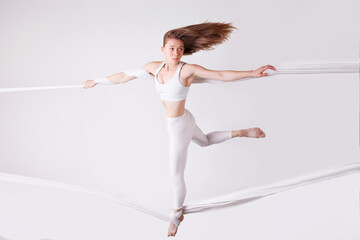 A female gymnast on gymnastic canvases