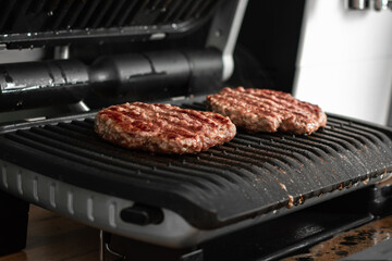 Juicy beef patty for burgers on a hot grill