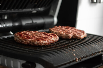 Freshly grilled burger meat. Burgers on the grill. Cooking burgers on hot grill