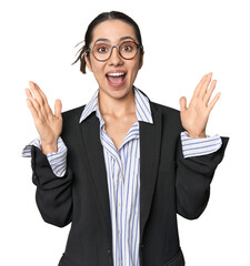 Confident young Caucasian businesswoman on studio background celebrating a victory or success, he is surprised and shocked.