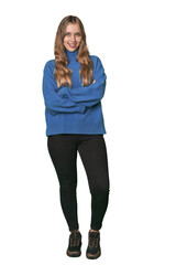 Studio portrait of a blonde Caucasian woman who feels confident, crossing arms with determination.