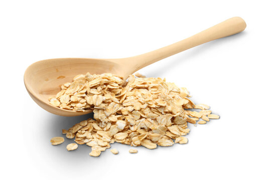 Heap of rolled oats with wooden spoon