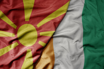 big waving national colorful flag of cote divoire and national flag of macedonia .