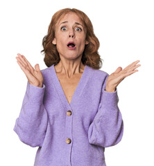 Redhead mid-aged Caucasian woman in studio surprised and shocked.