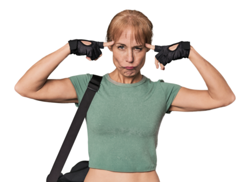 Mid-aged Caucasian athlete with gym bag focused on a task, keeping forefingers pointing head.