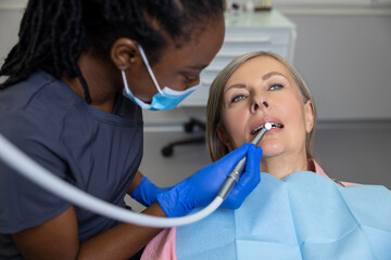 Woman sitting in dental chair teeth treatment