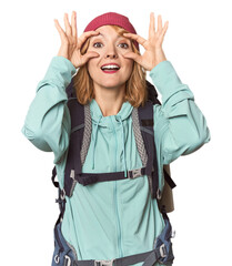 Middle-aged Caucasian woman with hiking gear keeping eyes opened to find a success opportunity.