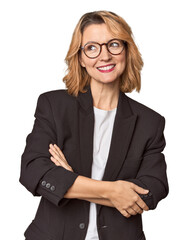 Caucasian woman in black business suit smiling confident with crossed arms.