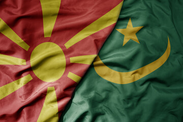 big waving national colorful flag of mauritania and national flag of macedonia .