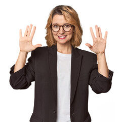 Caucasian woman in black business suit showing number ten with hands.