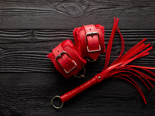 Set of BDSM toys over black wooden background
