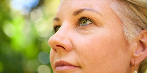 Close Up On Face Of Confident Mature Woman With Short Hair Standing Outdoors