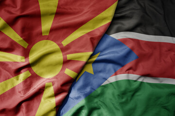 big waving national colorful flag of south sudan and national flag of macedonia .