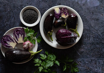 Purple vegetables arranged on a dark table