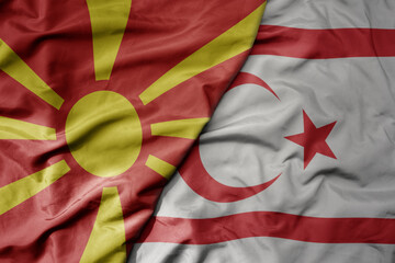 big waving national colorful flag of northern cyprus and national flag of macedonia .