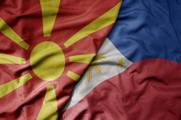 big waving national colorful flag of philippines and national flag of macedonia .