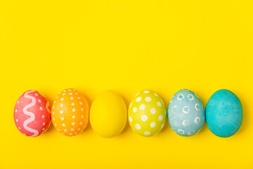 Easter eggs on a bright background. Easter celebration concept. Colorful easter handmade decorated Easter eggs. Place for text. Copy space.