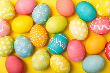 Fototapeta na wymiar Easter eggs on a bright background. Easter celebration concept. Colorful easter handmade decorated Easter eggs. Place for text. Copy space.