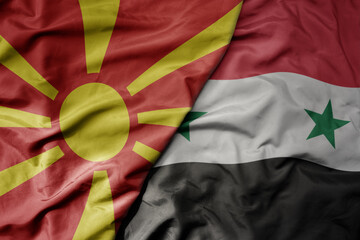 big waving national colorful flag of syria and national flag of macedonia .