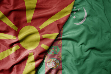 big waving national colorful flag of turkmenistan and national flag of macedonia .