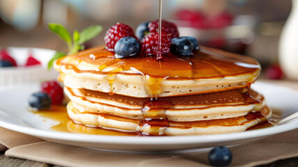 Stack of delicious blueberry pancakes drizzled with honey.