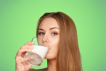 Young smiling woman hold glass of milk