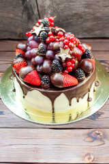 Delicious cheesecake with fresh strawberries, raspberries, blueberry, currants and grapes on wooden background, Free space for your text