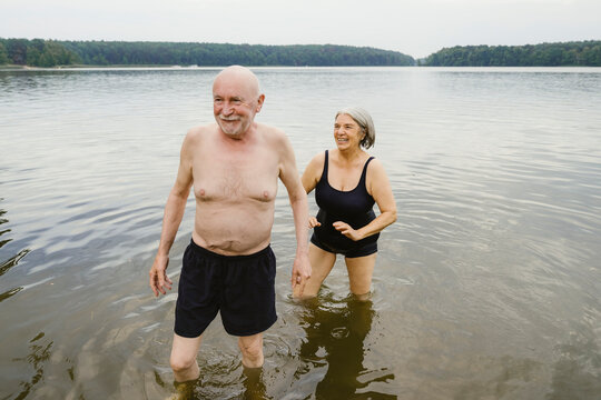 Happy senior couple enjoying at riverbank