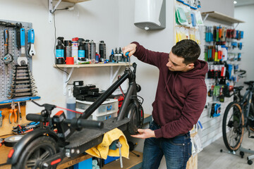Bike mechanic adjusting an electric scooter.