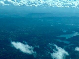 Aerial view of mountains and river from airplane. Cloudy day © asaleta