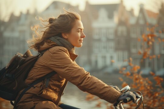 Side shot of a 25-year-old woman riding her bicycle on her way to work during spring season. A blurry residential area can be seen in the background