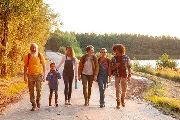 A heartwarming scene of multigenerational camaraderie is depicted in this image, where a group of...