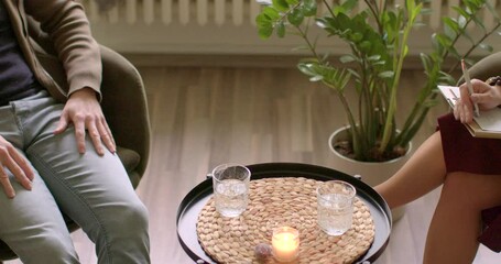 Two unidentifiable people indoor. Individual counseling session focusing on addiction recovery and overcoming dependencies. Personal therapy addressing addiction issues and journey towards recovery.