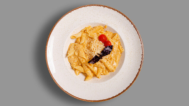 Pasta penne with cheesse top view isolated