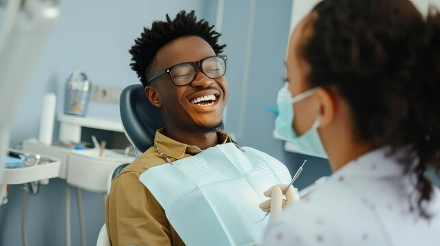 African American dentist examining teeth of her female patient during appointment at dental clinic.