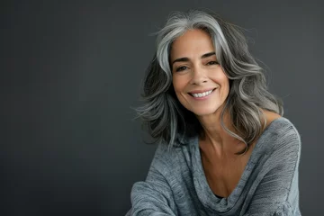 Foto op Aluminium Smiling natural beautiful middle-aged woman on a gray background © Goolya