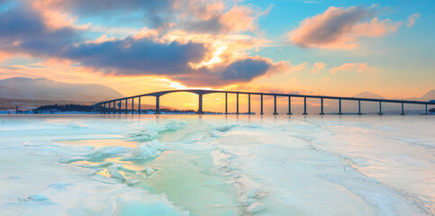 Arctic city of Tromso with Sandnessund bridge at sunset - Beautiful winter landscape with cracks on...