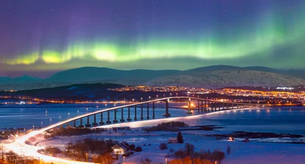 Fotobehang Aurora borealis or Northern lights in the sky over Tromso with Sandnessundet Bridge - Tromso, Norway © muratart