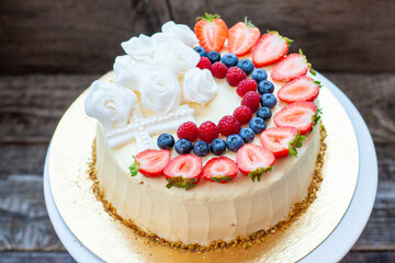 Christening cake for baby. Decoration with fresh berries and fondant flowers. Christening party...