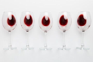 Many glasses of red wine at wine tasting. Concept of red wine on colored background. Top view, flat lay design